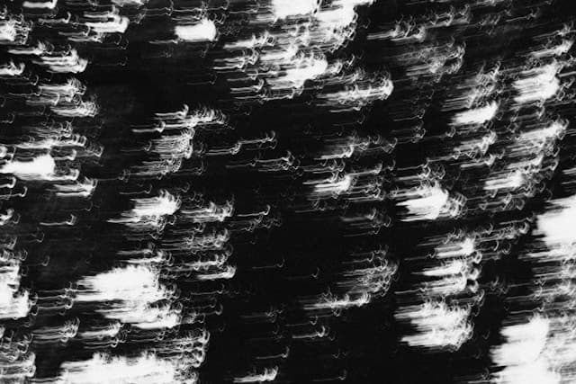 Abstract trails of light moving through darkness