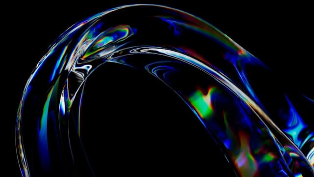 An iridescent arc emerging from a dark background